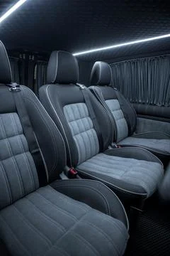 Comfortable interior of a passenger bus with soft seats Stock Photos