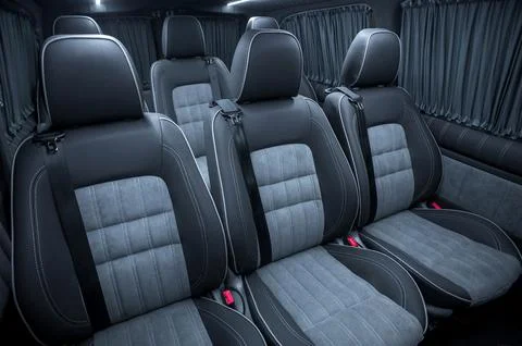 Comfortable interior of a passenger bus with soft seats Stock Photos