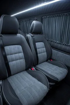 Comfortable interior of a passenger bus with soft seats Stock Photos