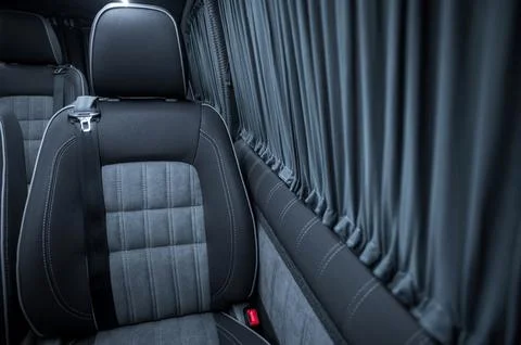 Comfortable interior of a passenger bus with soft seats Stock Photos