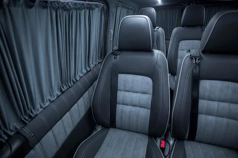 Comfortable interior of a passenger bus with soft seats Stock Photos