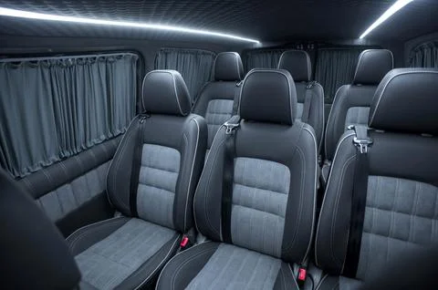 Comfortable interior of a passenger bus with soft seats Stock Photos