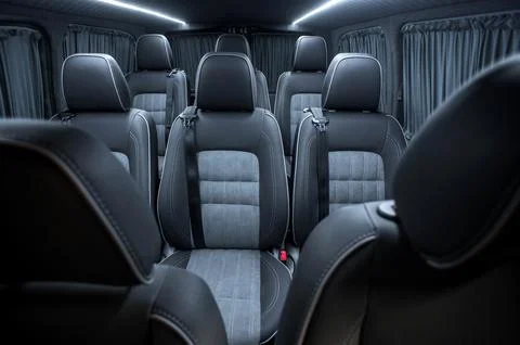 Comfortable interior of a passenger bus with soft seats Stock Photos