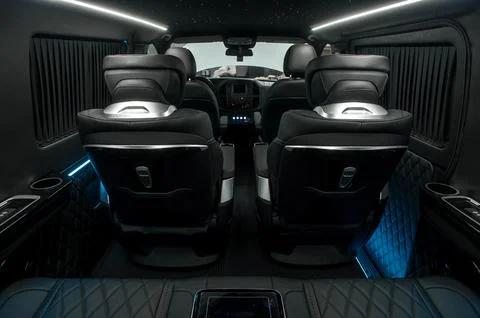 Comfortable interior of a passenger bus with soft seats Stock Photos