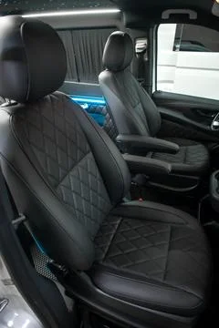 Comfortable interior of a passenger bus with soft seats Stock Photos