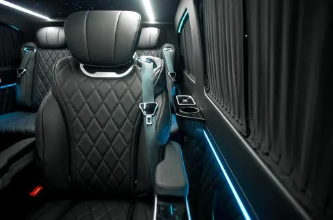 Comfortable interior of a passenger bus with soft seats Stock Photos