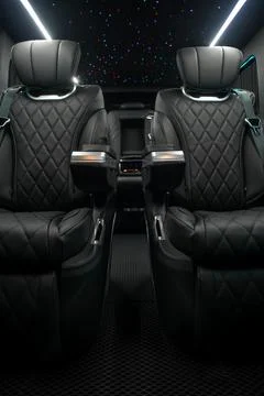 Comfortable interior of a passenger bus with soft seats Stock Photos