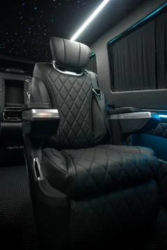 Comfortable interior of a passenger bus with soft seats Stock Photos