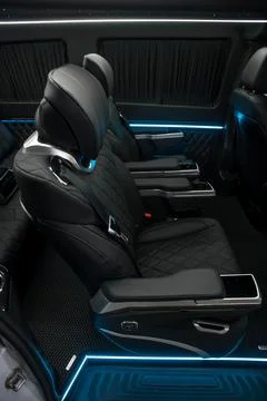 Comfortable interior of a passenger bus with soft seats Stock Photos