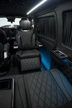 Comfortable interior of a passenger bus with soft seats Stock Photos