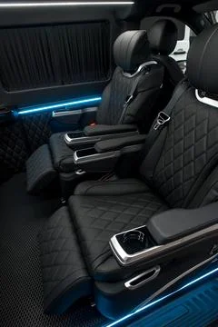 Comfortable interior of a passenger bus with soft seats Stock Photos