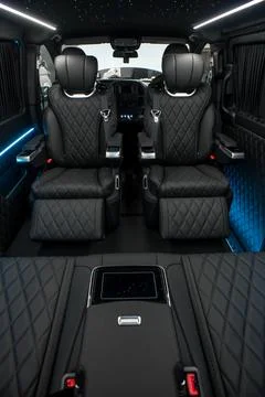 Comfortable interior of a passenger bus with soft seats Stock Photos