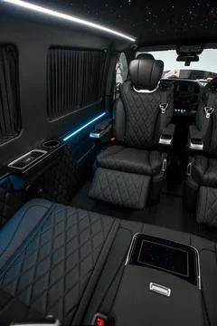 Comfortable interior of a passenger bus with soft seats Stock Photos