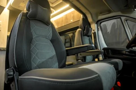 Comfortable interior of a passenger bus with soft seats Stock Photos
