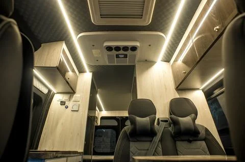 Comfortable interior of a passenger bus with soft seats Stock Photos