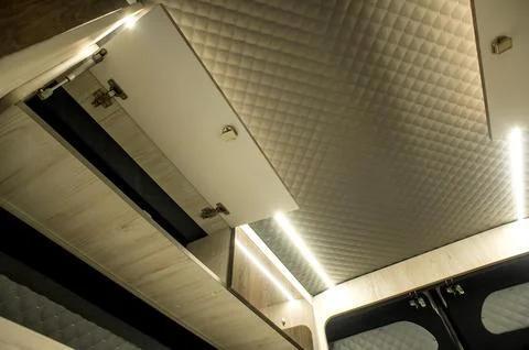 Comfortable interior of a passenger bus with soft seats Stock-Fotos