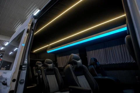 Comfortable interior of a passenger bus with soft seats Stock Photos