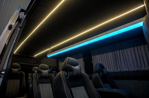Comfortable interior of a passenger bus with soft seats Stock Photos