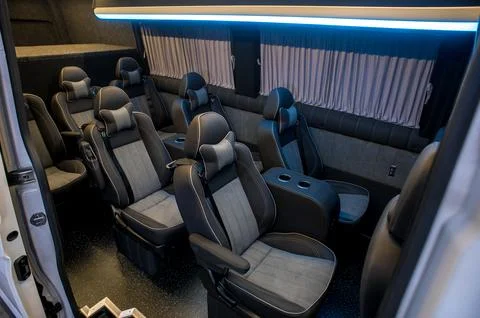 Comfortable interior of a passenger bus with soft seats Stock Photos