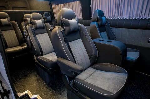 Comfortable interior of a passenger bus with soft seats Stock Photos