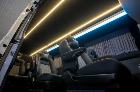Comfortable interior of a passenger bus with soft seats Stock Photos