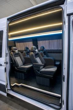 Comfortable interior of a passenger bus with soft seats Stock Photos