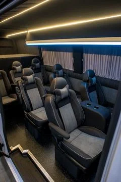 Comfortable interior of a passenger bus with soft seats Stock Photos