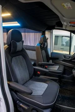 Comfortable interior of a passenger bus with soft seats Stock Photos