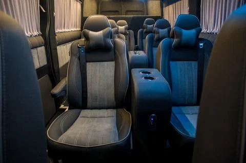 Comfortable interior of a passenger bus with soft seats Stock Photos