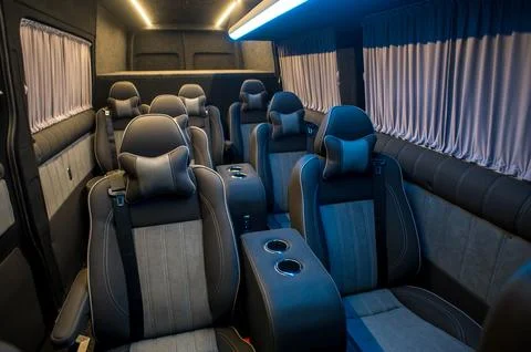 Comfortable interior of a passenger bus with soft seats Stock Photos