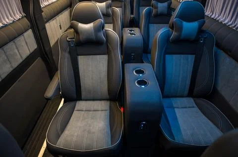 Comfortable interior of a passenger bus with soft seats Stock Photos
