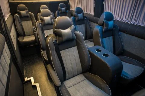 Comfortable interior of a passenger bus with soft seats Stock Photos