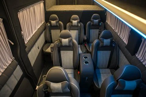 Comfortable interior of a passenger bus with soft seats Stock Photos