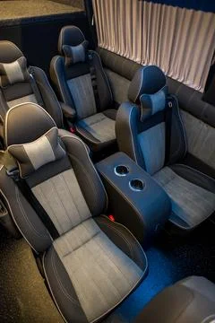 Comfortable interior of a passenger bus with soft seats Stock Photos