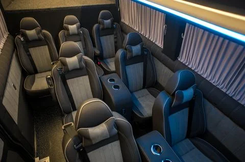 Comfortable interior of a passenger bus with soft seats Stock Photos