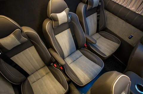 Comfortable interior of a passenger bus with soft seats Stock Photos