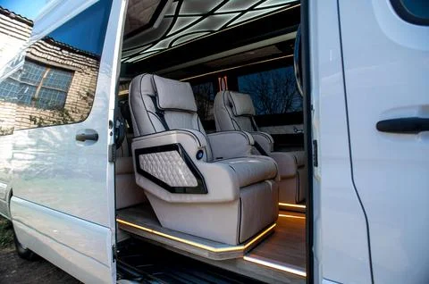 Comfortable interior of a passenger bus with soft seats Stock Photos