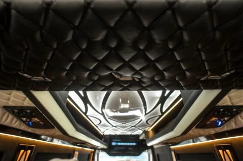 Comfortable interior of a passenger bus with soft seats Stock Photos