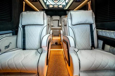 Comfortable interior of a passenger bus with soft seats Stock Photos