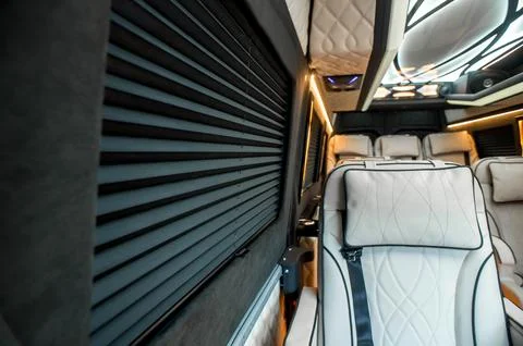Comfortable interior of a passenger bus with soft seats Stock Photos