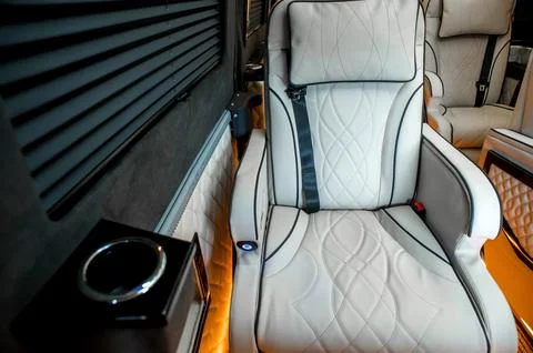 Comfortable interior of a passenger bus with soft seats Stock Photos
