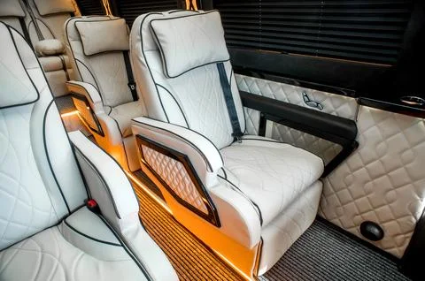 Comfortable interior of a passenger bus with soft seats Stock Photos