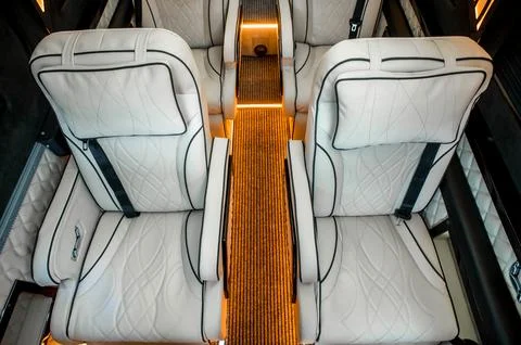 Comfortable interior of a passenger bus with soft seats Stock Photos