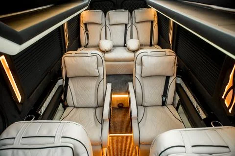 Comfortable interior of a passenger bus with soft seats Stock Photos