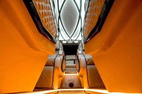 Comfortable interior of a passenger bus with soft seats Stock Photos