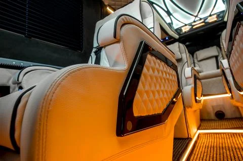 Comfortable interior of a passenger bus with soft seats Stock Photos