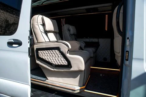 Comfortable interior of a passenger bus with soft seats Stock Photos