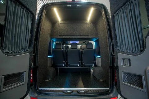 Comfortable interior of a passenger bus with soft seats Stock Photos