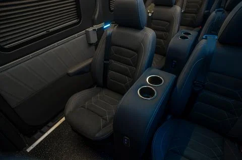 Comfortable interior of a passenger bus with soft seats Stock Photos