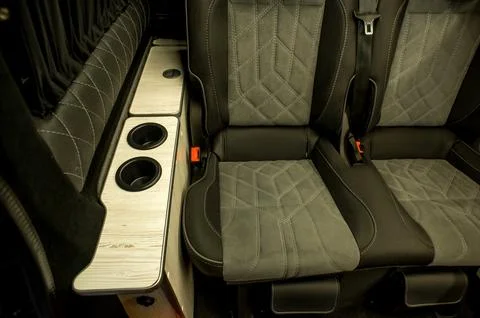 Comfortable interior of a passenger bus with soft seats Stock Photos